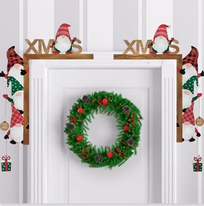 Close-up of wooden Christmas gnome door corner decor with XMAS lettering and plaid hats