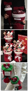 Detailed view of Christmas apple bouquet wrapping paper with plush red fabric and bells