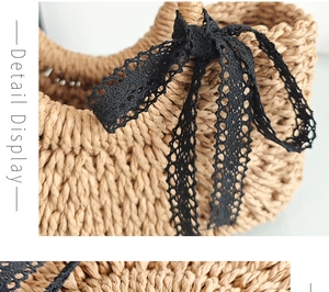 Close-up of hand-woven straw bag texture featuring delicate black lace bow accents