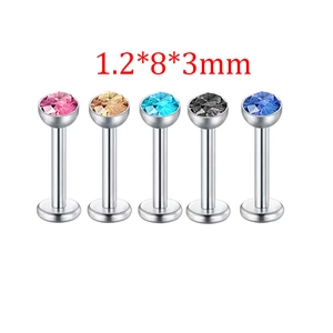 Detail view of five 1.2x8x3mm stainless steel labret studs with colorful cubic zirconia