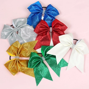 Detail of 6 glittery bow hair ties with rhinestones in blue, silver, red, gold, green, white