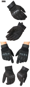Detail of black tactical gloves featuring hard shell knuckle protection and wrist strap