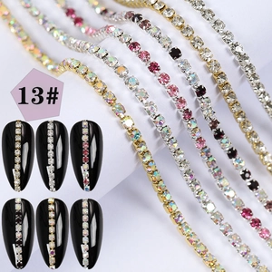 Macro detail of mixed color rhinestones on metal chains for creative nail art design
