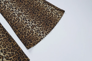 Detail of leopard print jumpsuit showing high-quality stitching on flared leg hems