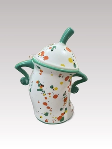 Detail of white ceramic canister with green handle and colorful speckled pattern
