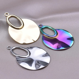 Set of three geometric stainless steel pendant charms in gold, silver, and rainbow finishes
