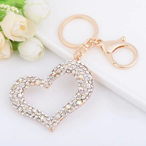 Sparkling heart-shaped gold keychain with crystal rhinestones on a clean white surface