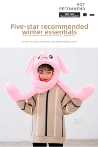Detailed view of pink plush rabbit ears hat with cute embroidery for winter warmth