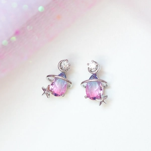 Detail of moon and star stud earrings with blue-pink gradient teardrop crystals