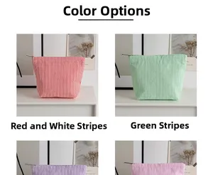 Detailed view of seersucker makeup bags showing red and green striped fabric patterns
