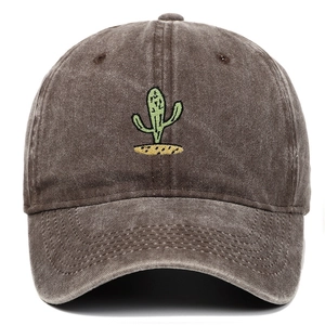 Close-up of vintage washed brown baseball cap featuring green cactus embroidery detail