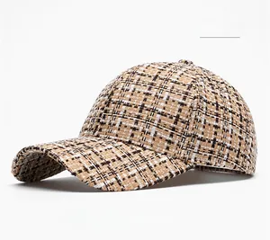 Close-up of khaki plaid tweed texture on a stylish baseball cap with woven finish