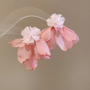 Detailed view of pink fabric floral earrings with semi-translucent petals for women
