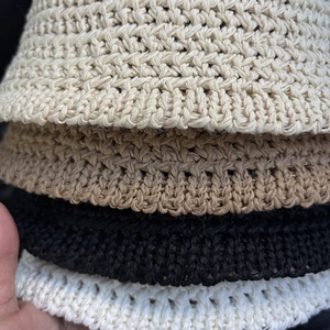 Foldable crochet bucket hats in beige, camel, black, and white with hollow knit texture