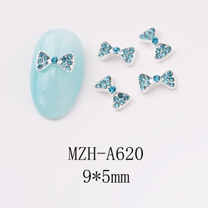 Close-up of blue bow nail charms with 9x5mm dimensions for manicured nail art decor