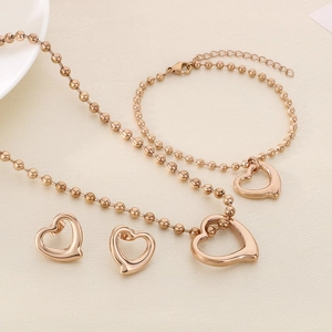 Detailed view of rose gold hollow heart pendant jewelry set with round bead chains