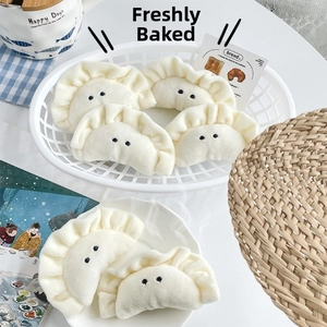 Detailed view of plush dumpling keychains with soft fabric and ruffled edges