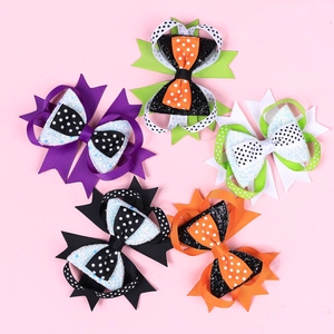 Detail view of multi-layered Halloween hair bows with sequins, glitter and spider web patterns