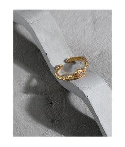 Macro detail of S925 sterling silver ring with lava texture and pink zircon stone
