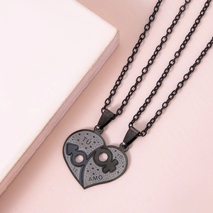 Detail of heart puzzle couple necklaces with gender symbols and Spanish love engraving