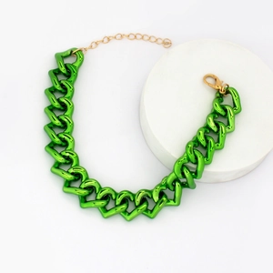 Detail of green metallic heart link pet collar with golden lobster clasp on white background