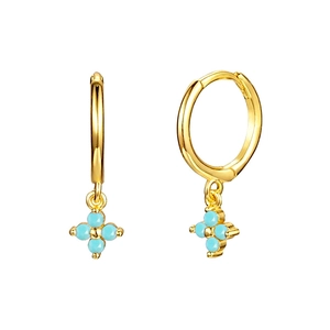 Close-up of gold hoop earrings with light blue four-petal floral dangles on white background