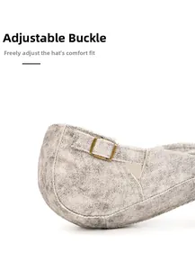 Detail of vintage washed denim newsboy cap with adjustable bronze metal buckle and strap
