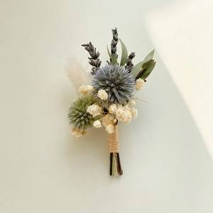 Detailed close-up of handmade dried flower boutonniere with lavender and eucalyptus leaves