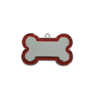 Detail of bone-shaped pet ID tag with sparkling red glitter and polished silver zinc alloy