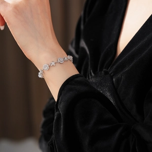 Detail of silver flower bracelet with chalcedony and zircons on a model wrist