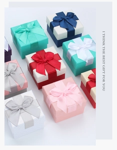 Top view of square jewelry gift boxes with satin ribbons in various elegant colors