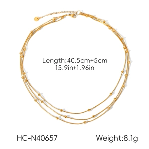 Detailed view of triple-layered gold bead chain necklace with size and weight specs