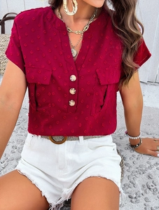 Close-up of burgundy V-neck chiffon blouse with decorative buttons and front pockets