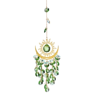 Detail of golden sun and moon ornament with green crystal beads and sparkling fringe
