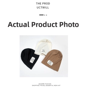 Flat lay of knit beanies in black, off-white, and brown with woven brand labels