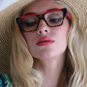 Close-up of tricolored retro oversized glasses frames on model for holiday style