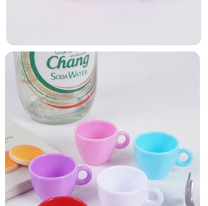 Detailed view of colorful miniature plastic coffee cups for dollhouse DIY craft projects