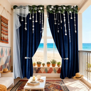 Detail of dark blue velvet Christmas curtain with pine needle decor and white snowballs