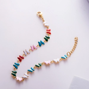 Golden titanium bracelet featuring colorful enamel butterflies and adjustable lobster clasp
