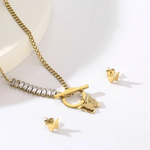 Detailed set of gold butterfly jewelry with square cubic zirconia and a T-bar link chain
