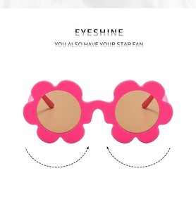 Detail of rose pink flower-shaped sunglasses with brown lenses and a durable plastic frame