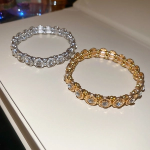 Close-up of gold and silver elastic bracelets with sparkling crystal stones in a macro view