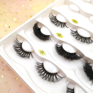 Macro shot of 5D Russian volume eyelashes in 24, 32, and 34 styles on pink star tulle