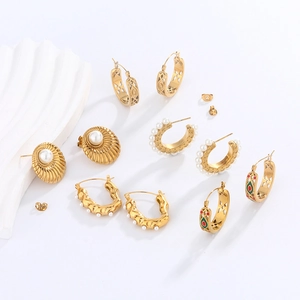 Detailed selection of gold earrings with pearls, shell shapes and colorful enamel charms