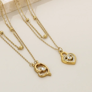 Detailed view of gold-plated double-layer necklace with diamond heart lock pendants