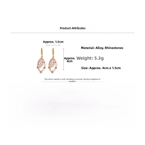 Detail view showing golden oval pendant earrings with pink rhinestones and sizing metrics