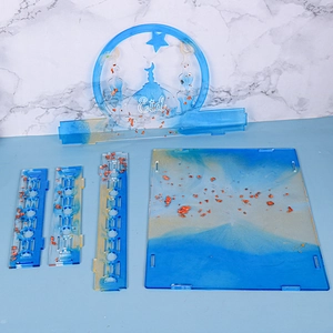 Macro shot of Eid themed resin art parts with mosque silhouette and gold foil flakes