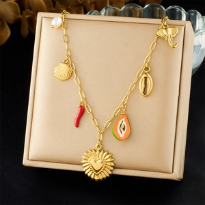 Detail of gold-plated stainless steel charm bracelet with shell and flower charms