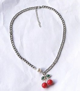 Silver cuban chain necklace featuring a red cherry pendant and white pearl accent