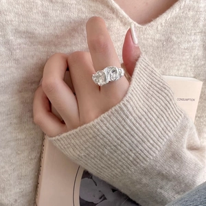 Close-up of a 925 silver irregular crushed foil texture ring worn by a model